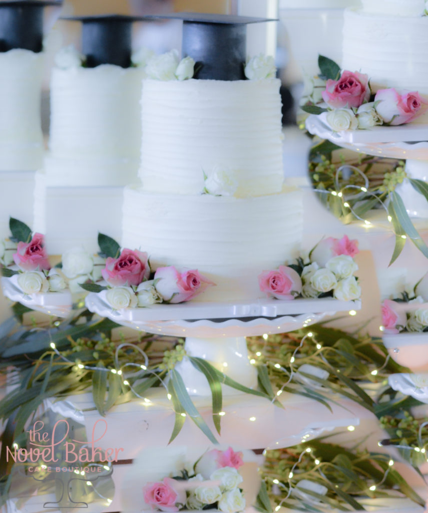 Buttercream 2 tier cake with pink roses and black cap